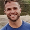 headshot of man, Huw Brassington with coastal headland in the background.jpg