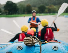 two people White Water Rafting and instructor.