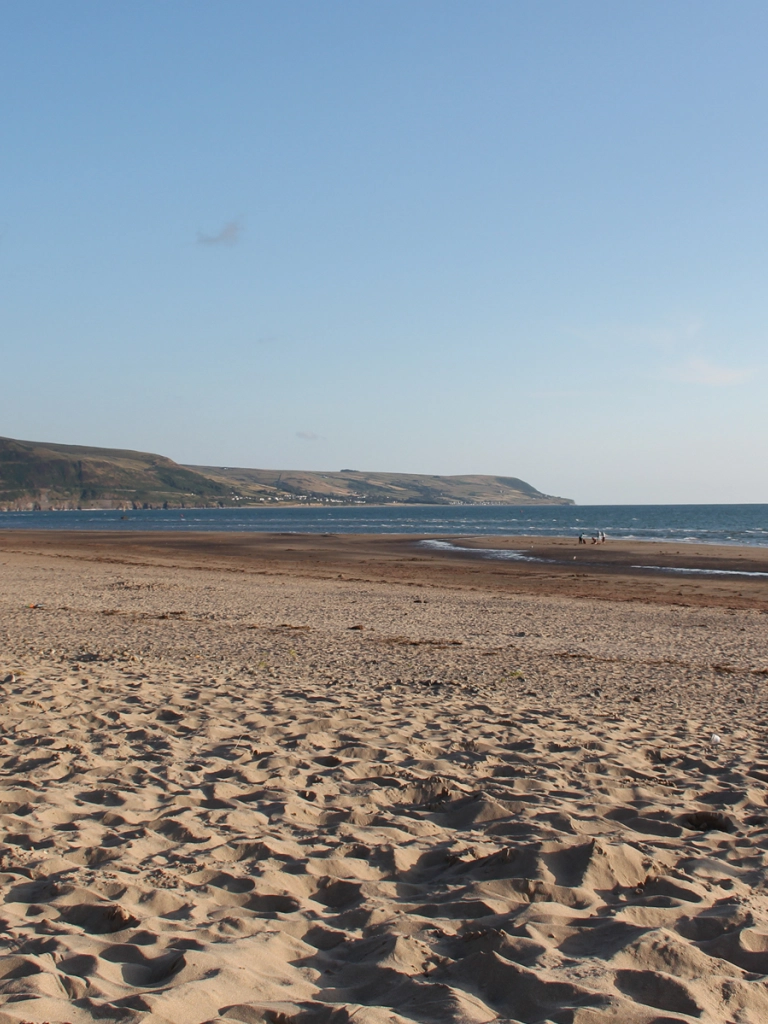 Traeth eang, tywodlyd.