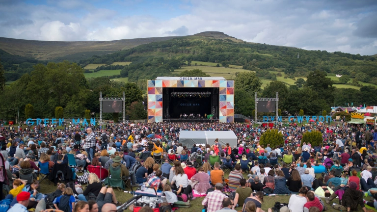 Llwyfan mewn gŵyl mewn cae.