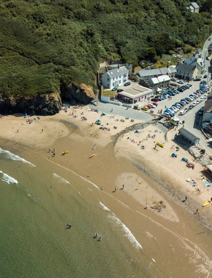 Awyrlun o draeth Llangrannog, y môr a'r adeiladau cyfagos.