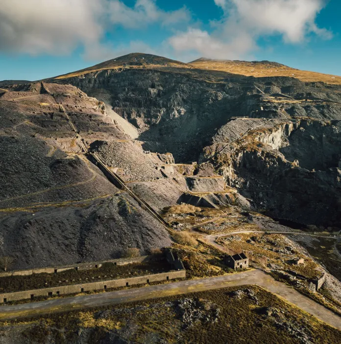 Aerial view of a slate quarry showing ruined workshops, inclines and slate waste heaps.