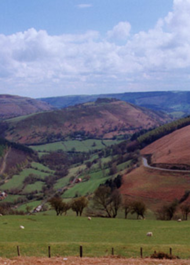 field with hills and road.