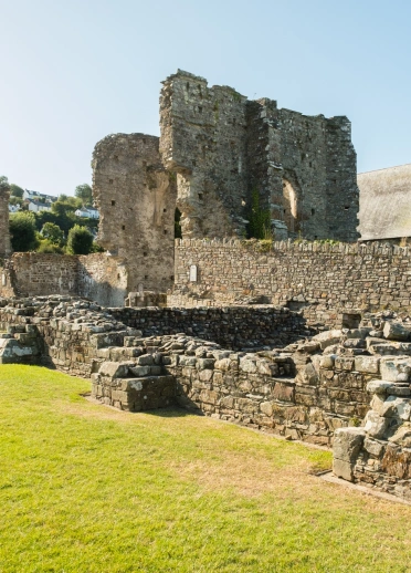 A ruined stone abbey with varying height walls.