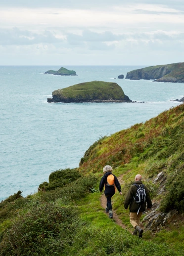 Walkers on Porth Ysgo, Llŷn Peninsula.