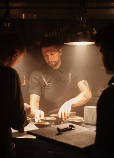 three chefs preparing food.