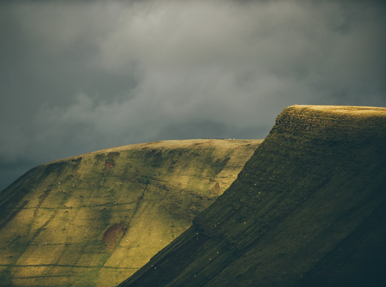Grass covered mountainsides.