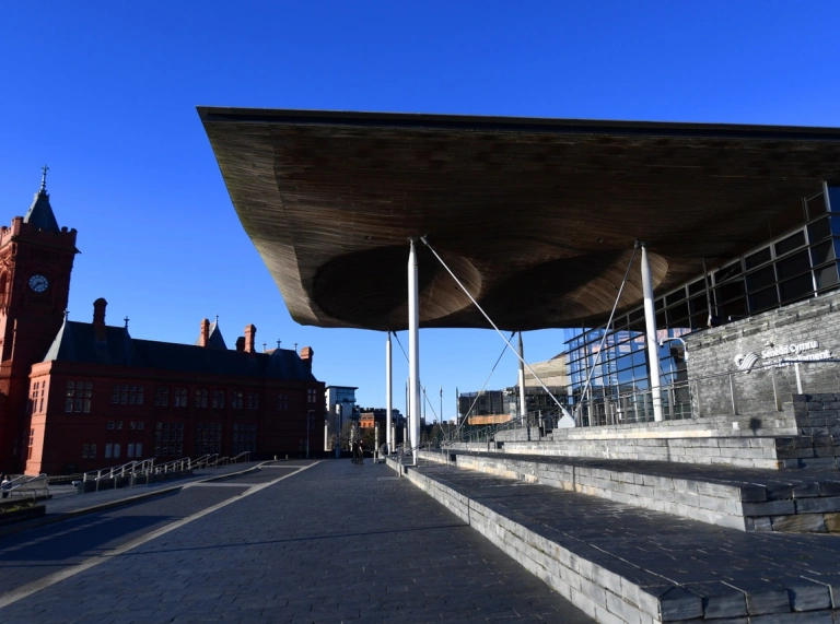 Grisiau yn arwain i'r Senedd gyda adeilad y Pierhead yn y cefndir