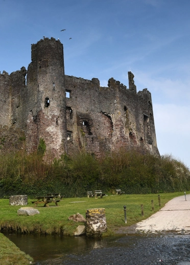 Castell adfeiliedig wrth yr arfordir.