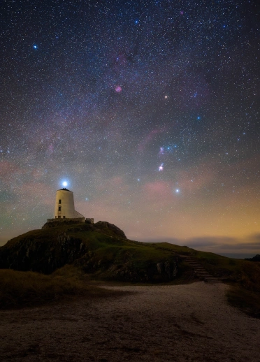 dark skies above lighthouse.