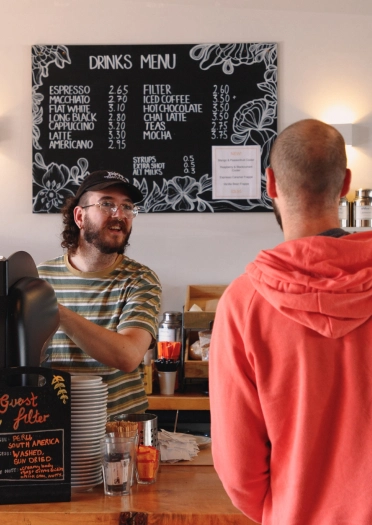 customer being served at till.