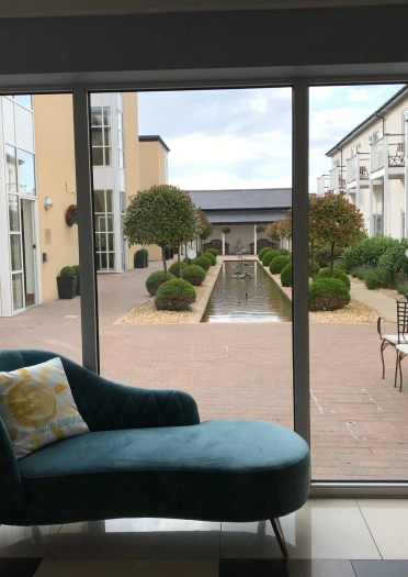 chaise lounge and view of hotel courtyard.