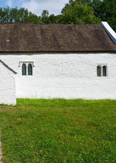 Outside of a white church with a path leading to the door