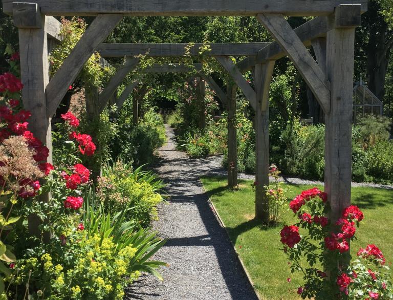 The garden with flowers and wooden trellises at Nantclwyd y Dre.