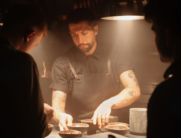 three chefs preparing food.