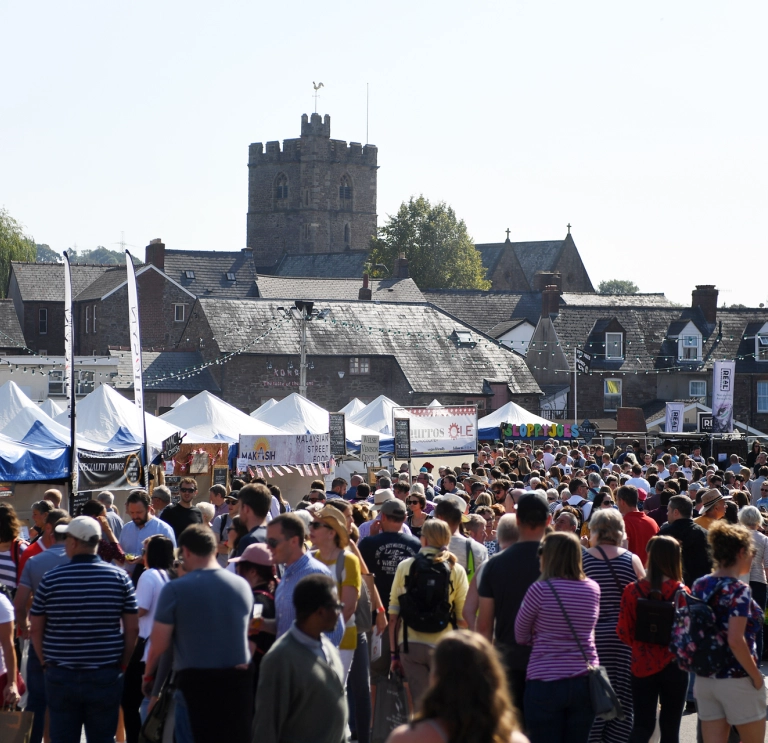crowd at a busy outdoor food festival.