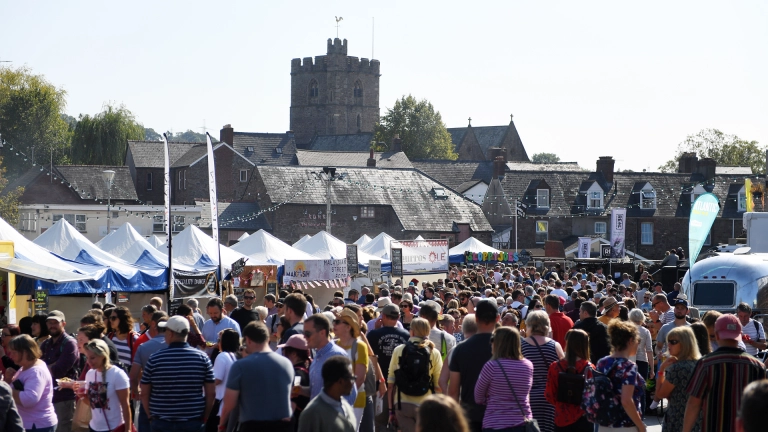 crowd at a busy outdoor food festival.