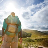 man with a backpack hiking through the Bannau Brycheiniog (Brecon Beacons).