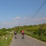 Cyclists on a road in the countryside.