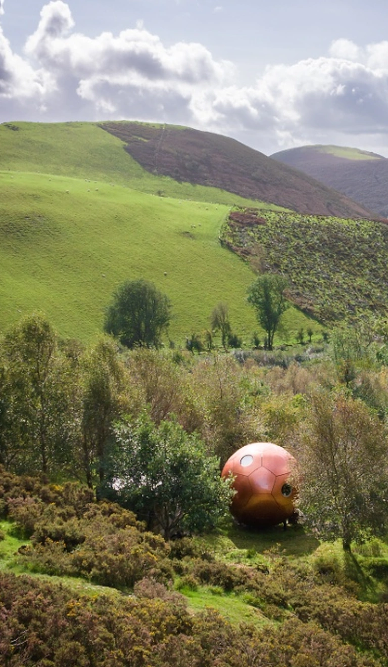 Caban siâp cocŵn yn yr awyr agored sy’n cynnig llety.